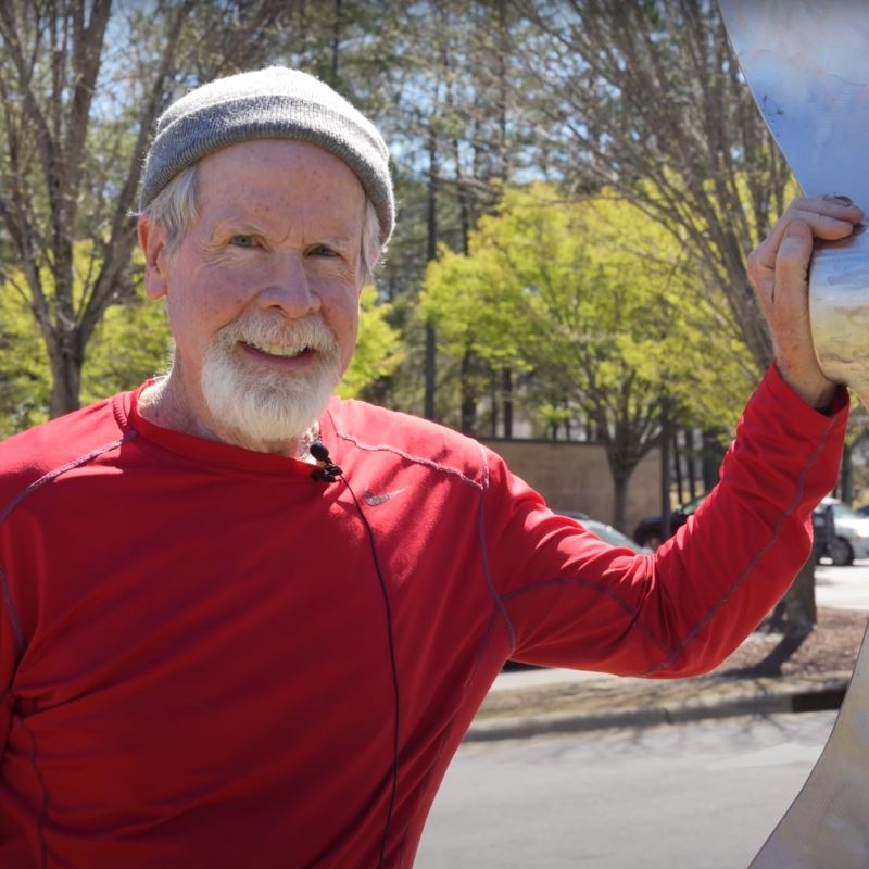 Joe Coates leans on scupture Oh Deer