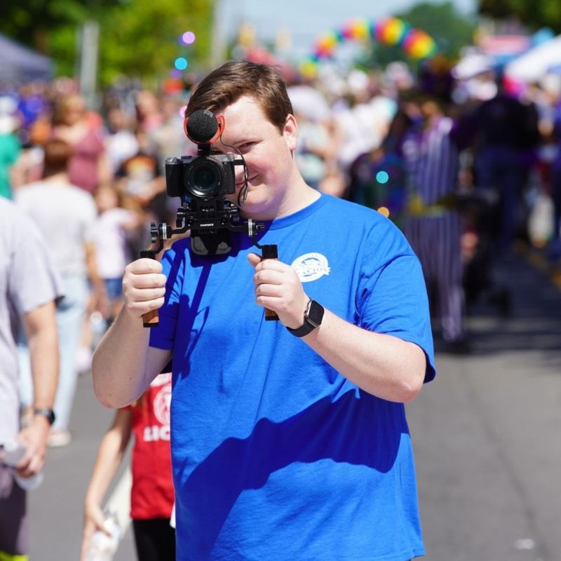 Town of Clayton communication intern holds camera
